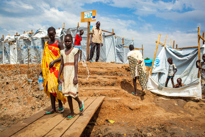 South Sudanese children walk around in a refugee camp