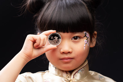 Catriona Lee, aged 9, presents The Royal Mint’s latest Chinese zodiac coin from the Shengxiao Collection, depicting the Lunar Year of the Rat to celebrate Chinese New Year on Saturday.