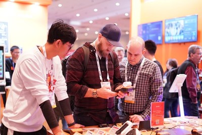 Customers are visiting SUNMI's booth to experience new products