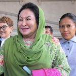 Rosmah turns up for graft trial on a wheelchair, ambulance in tow