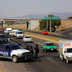 Gunfire, burning vehicles in Mexican city, officials deny gang leader held