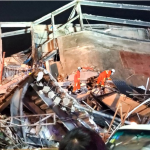 Ten die at collapsed China quarantine hotel; virus spread slows