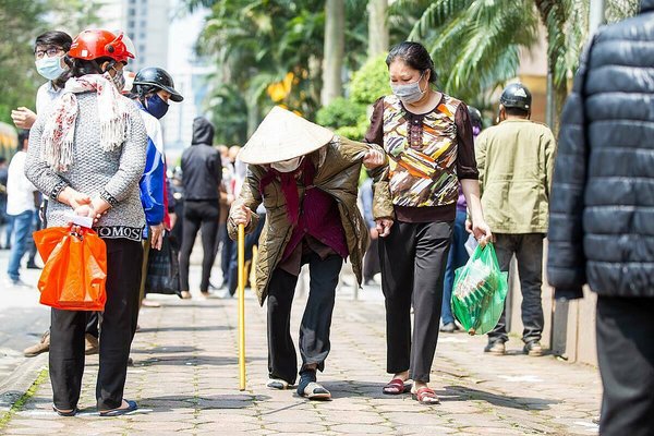 An 87-year-old woman makes her way to The Zero Cost Supermarket in Hanoi, Vietnam, on April 15, 2020. (Photo by VnExpress/Tung Dinh)