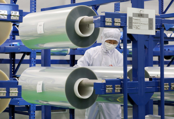 An employee of SK IE Technology is checking the FCW products soon to be supplied to a global smartphone manufacturer at FCW factory in Jeungpyeong, North Chungcheong Province, South Korea.