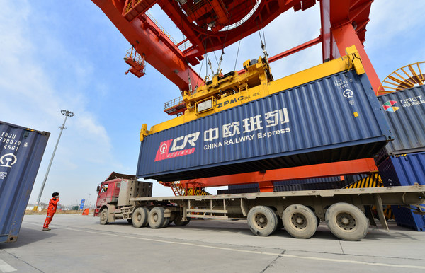 A worker directs container hoisting operation at a logistic station in Xinzhu Railway Station in Xi'an, March 11, 2020. A worker directs container hoisting operation at a logistic station in Xinzhu Railway Station in Xi'an, March 11, 2020.
