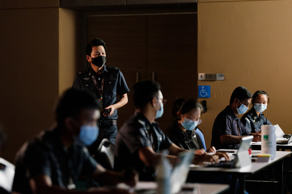 A Certis Auxiliary Police Officer in the command centre at a Government Quarantine Facility A Certis Auxiliary Police Officer in the command centre at a Government Quarantine Facility