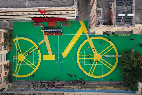 A sports ground donated to a rural primary school in Sichuan province, created with recycled materials from 3,500 Meituan Bikes tires