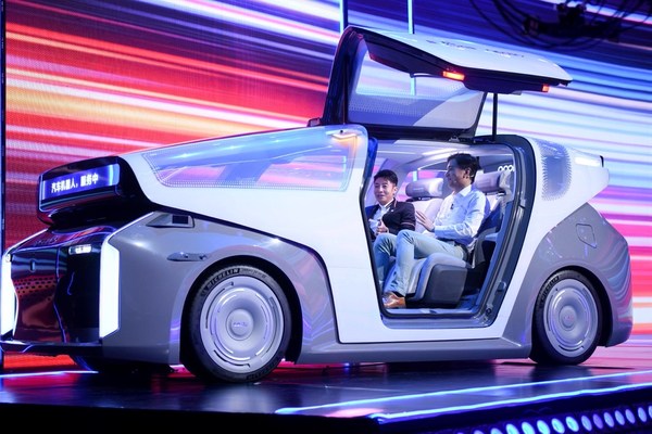 Baidu Co-founder and CEO Robin Li and CCTV host Beining Sa sit in Baidu’s newly launched robocar
