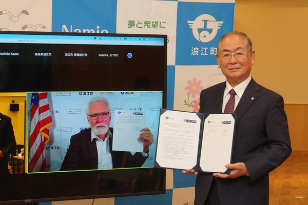 Namie, Japan, Mayor Yoshida holds a signed partnership declaration in person as Lancaster, CA, Mayor Parris holds the corresponding document online. Namie, Japan, Mayor Yoshida holds a signed partnership declaration in person as Lancaster, CA, Mayor Parris holds the corresponding document online.
