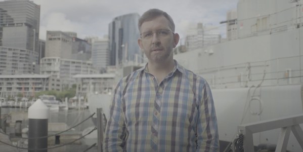 Dr James Curran in front of the ship