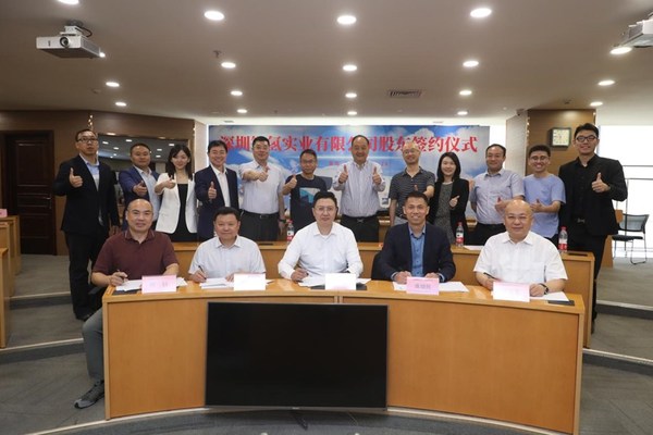 The picture of the five parties signing a share purchase agreement The picture of the five parties signing a share purchase agreement