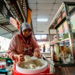 Previous tough times prompt Kak Chah to offer free nasi lemak to students