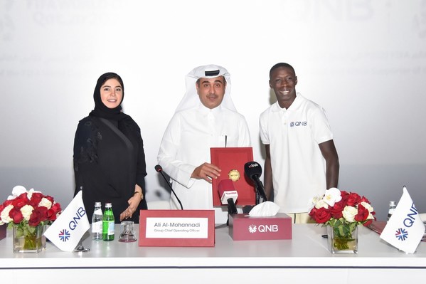 Internet sensation Khabane "Khaby" Lame, the world’s most followed person on TikTok, is pictured at the official signing ceremony with Ali Rashid Al-Mohannadi, QNB Group Executive General Manager & Group Chief Operating Officer, and Heba Ali Al-Tamimi, QNB Group General Manager Group Communications