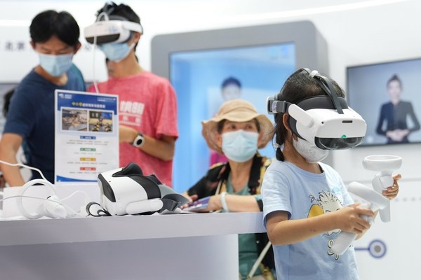 A girl tries a VR device at the cultural and tourism services exhibition hall in the Shougang Park during the 2022 CIFTIS in Beijing, capital of China, Sept. 4, 2022. (Xinhua/Ju Huanzong)