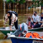 Family of five brave through stagnant floodwaters to vote