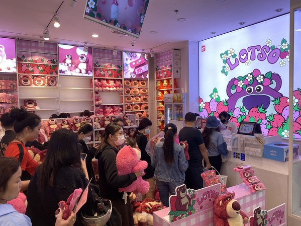 Shoppers waiting in line to check out with Lotso purchases