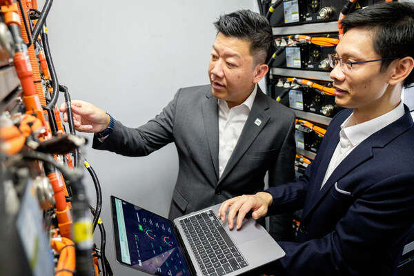 Durapower Group CEO Mr Kelvin Lim (left) and NTU Assistant Professor Hung Dinh Nguyen (right) discussing the AI-powered technology test-bedded in the container-sized energy storage solution, containing Durapower lithium-ion batteries and battery management systems. Asst Prof Hung is holding a laptop showing the cloud-based AI-powered digital twin platform jointly developed by NTU and Durapower to better predict battery performance, enhancing system safety and extending the life of the batteries. Image: NTU Singapore Durapower Group CEO Mr Kelvin Lim (left) and NTU Assistant Professor Hung Dinh Nguyen (right) discussing the AI-powered technology test-bedded in the container-sized energy storage solution, containing Durapower lithium-ion batteries and battery management systems. Asst Prof Hung is holding a laptop showing the cloud-based AI-powered digital twin platform jointly developed by NTU and Durapower to better predict battery performance, enhancing system safety and extending the life of the batteries. Image: NTU Singapore