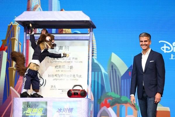 Josh D'Amaro, Chairman of Disney Experiences, interacts with Zootopia’s Duke Weaselton