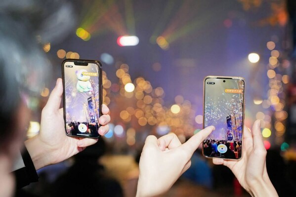 Tourists amazed by the AR street view of Jiaozi Avenue using their mobile phones Tourists amazed by the AR street view of Jiaozi Avenue using their mobile phones