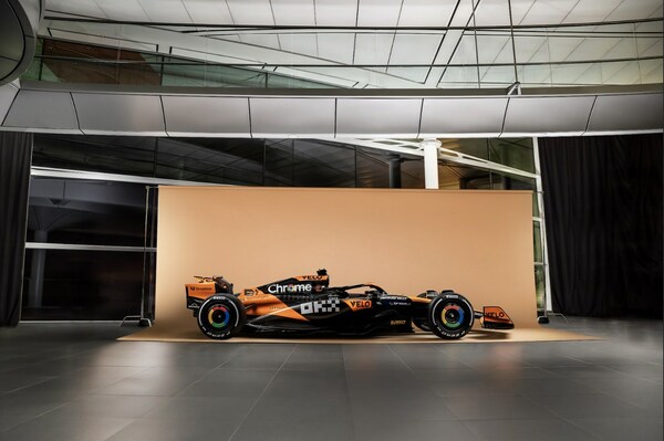 A side view of the MCL38 race car featuring OKX branding