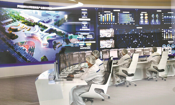 Staff members of the Yili Group, a major dairy producer, monitor production of a dairy factory in real-time at a digital center in Hohhot, Inner Mongolia, in 2022. [Photo provided to China Daily]