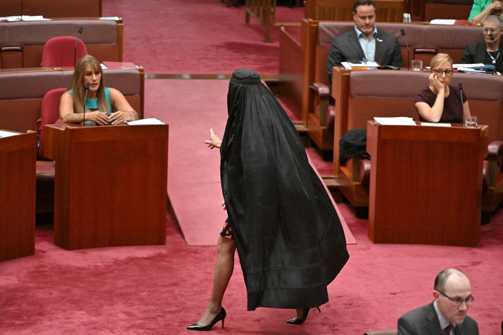 Burqa stunt earns Pauline Hanson seven-day suspension amid fierce condemnation from Australian Senate