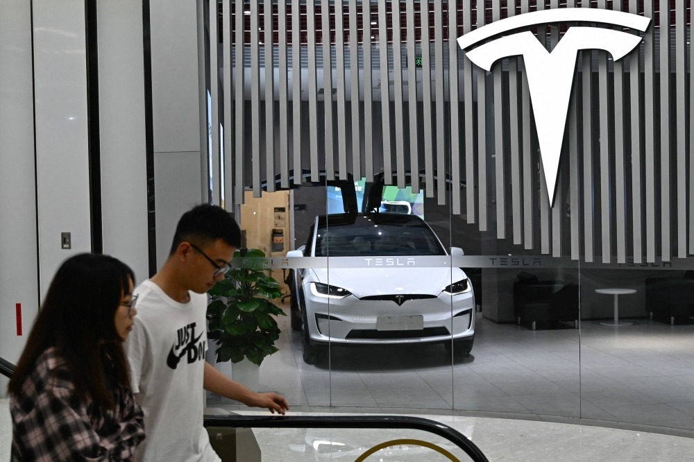 Millions of Teslas recalled in China over door‑handle hazard and steering‑assist issues