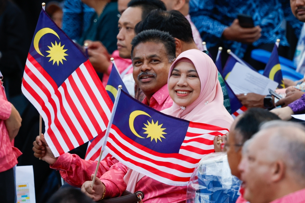 Tens of thousands gather before sunrise as favourable weather lifts National Day spirit