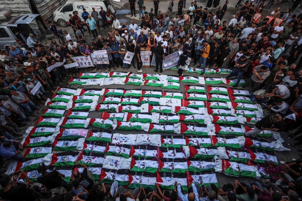 Gaza mourns 100 victims recovered from rubble in one of its largest funerals