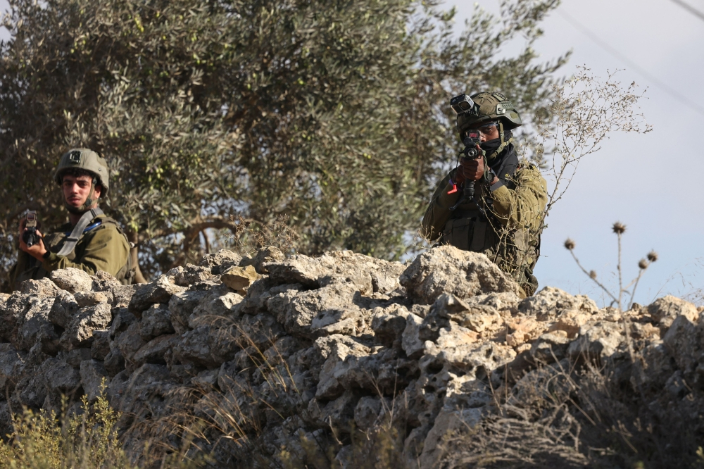 Palestinians injured as Israeli forces help settlers seize West Bank olive groves